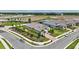 Expansive aerial shot of a beautifully landscaped property near a serene pond and community park, showcasing its prime location at 3679 Santa Caterina Blvd, Bradenton, FL 34211