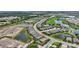 Aerial view showcases a home's location amidst community amenities, including ponds, a golf course, and lush green spaces at 3679 Santa Caterina Blvd, Bradenton, FL 34211