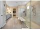 This luxurious bathroom features a glass shower, double vanity, and spacious walk-in closet at 3679 Santa Caterina Blvd, Bradenton, FL 34211