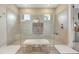 This luxurious shower features dual shower heads, bench seating, and bright tile at 3679 Santa Caterina Blvd, Bradenton, FL 34211
