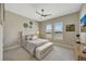 This cozy bedroom features a ceiling fan, shuttered windows, and bench with storage at 3679 Santa Caterina Blvd, Bradenton, FL 34211