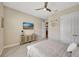 Cozy bedroom featuring a ceiling fan, TV, modern furniture, and neutral color palette at 3679 Santa Caterina Blvd, Bradenton, FL 34211