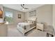 This cozy bedroom features a ceiling fan, shuttered windows, and a calm neutral color palette at 3679 Santa Caterina Blvd, Bradenton, FL 34211