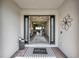 Open entryway featuring a decorative rug, black trimmed doorway, and views of the living room at 3679 Santa Caterina Blvd, Bradenton, FL 34211