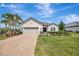 Beautiful one-story home featuring a well-manicured lawn, brick driveway, and a two-car garage at 3679 Santa Caterina Blvd, Bradenton, FL 34211
