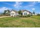 Well-maintained single-story home with a manicured lawn, driveway, and lush landscaping under a bright blue sky at 3679 Santa Caterina Blvd, Bradenton, FL 34211