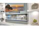 Modern fireplace featuring a mantle, shelves, lighting, and a mounted television at 3679 Santa Caterina Blvd, Bradenton, FL 34211