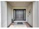 Inviting front entrance with double doors, decorative flower, 'Welcome' mat, sidelights, and neutral color scheme at 3679 Santa Caterina Blvd, Bradenton, FL 34211