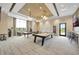Bright game room features a pool table, table tennis, comfortable seating, and a stylish bar area with modern lighting at 3679 Santa Caterina Blvd, Bradenton, FL 34211