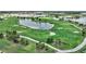 Aerial view of a meticulously manicured golf course with pristine greens, scenic lakes, and surrounding residences at 3679 Santa Caterina Blvd, Bradenton, FL 34211