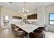 Stylish clubhouse kitchen featuring a long countertop, modern cabinetry, and modern lighting at 3679 Santa Caterina Blvd, Bradenton, FL 34211