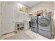 Modern laundry room with washer, dryer, storage, and countertop space for convenience at 3679 Santa Caterina Blvd, Bradenton, FL 34211