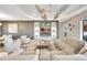 Spacious living room featuring stylish decor, modern ceiling fan, and built-in shelving at 3679 Santa Caterina Blvd, Bradenton, FL 34211