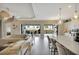 Open-concept living room and kitchen featuring hardwood floors and sliding glass doors to the backyard at 3679 Santa Caterina Blvd, Bradenton, FL 34211