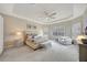 Serene main bedroom with tray ceiling, soft lighting, and ample natural light through shuttered windows at 3679 Santa Caterina Blvd, Bradenton, FL 34211