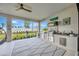 Outdoor kitchen featuring stainless steel appliances, granite countertop, and a cozy rug overlooking the backyard at 3679 Santa Caterina Blvd, Bradenton, FL 34211