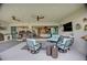Relaxing covered patio featuring cozy seating, stylish decor, and an open view into the home's interior at 3679 Santa Caterina Blvd, Bradenton, FL 34211