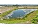 Scenic view of a serene community pond surrounded by lush greenery, creating a peaceful and natural ambiance at 3679 Santa Caterina Blvd, Bradenton, FL 34211