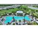 Stunning aerial view of community pool and Bahama Bar area with lush landscaping at 3679 Santa Caterina Blvd, Bradenton, FL 34211