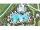 Aerial view of a uniquely shaped community pool with palm trees and lounge areas at 3679 Santa Caterina Blvd, Bradenton, FL 34211
