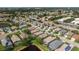 An aerial view shows the community and the home's proximity to a pond, street, and other houses at 3740 Summerwind Cir, Bradenton, FL 34209