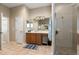 Bathroom with double sinks, wood cabinets, a large mirror, and a glass-enclosed shower at 3740 Summerwind Cir, Bradenton, FL 34209