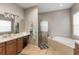 Bright bathroom featuring double sinks, a soaking tub, and a separate glass shower at 3740 Summerwind Cir, Bradenton, FL 34209