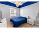 Cozy bedroom with a striking blue ceiling, a comfortable bed, and ample natural light at 3740 Summerwind Cir, Bradenton, FL 34209
