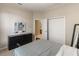 Bedroom with neutral walls, dark wood dresser, and ensuite bathroom access with closet at 3740 Summerwind Cir, Bradenton, FL 34209