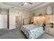 Spacious bedroom showcases tray ceiling, carpet floors, and access to ensuite bathroom at 3740 Summerwind Cir, Bradenton, FL 34209