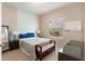Well-lit bedroom featuring neutral walls, a comfortable bed, and a writing desk near the window at 3740 Summerwind Cir, Bradenton, FL 34209