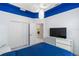 Bedroom featuring a blue accent ceiling, white walls, and closet space, with laundry access at 3740 Summerwind Cir, Bradenton, FL 34209