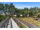 Wooden bridge overlooking beautiful green space and mature trees in a quiet neighborhood at 3740 Summerwind Cir, Bradenton, FL 34209