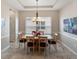 Dining room boasts natural light from a large window and a contemporary chandelier at 3740 Summerwind Cir, Bradenton, FL 34209