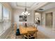 Formal dining room with a large window, elegant chandelier, and tray ceiling at 3740 Summerwind Cir, Bradenton, FL 34209