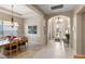 Elegant foyer with high ceilings, open dining space, and bright tile flooring creates an inviting atmosphere at 3740 Summerwind Cir, Bradenton, FL 34209