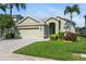 Charming one-story home featuring a two-car garage, lush lawn, and delightful landscaping at 3740 Summerwind Cir, Bradenton, FL 34209
