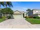 Charming one-story home featuring a two-car garage, lush lawn, and delightful landscaping at 3740 Summerwind Cir, Bradenton, FL 34209