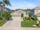 Inviting single-Gathering home boasts mature trees, lush landscaping, and a convenient two-car garage at 3740 Summerwind Cir, Bradenton, FL 34209