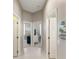 Bright hallway featuring neutral tones, tiled floors, and multiple doorways leading to different rooms at 3740 Summerwind Cir, Bradenton, FL 34209