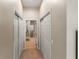 Hallway with carpeted floors, leading to a bathroom with tile flooring and modern fixtures at 3740 Summerwind Cir, Bradenton, FL 34209