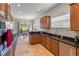 Well-lit kitchen with black granite countertops, wood cabinets, and stainless steel appliances at 3740 Summerwind Cir, Bradenton, FL 34209