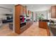 Modern kitchen with stainless steel appliances, wood cabinetry, and an open view to the living space at 3740 Summerwind Cir, Bradenton, FL 34209