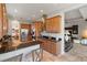 An open kitchen with wood cabinets, stainless steel appliances, and an adjacent dining area at 3740 Summerwind Cir, Bradenton, FL 34209