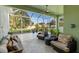 The screened lanai offers a ceiling fan, tile floor, and ample space for seating and potted plants at 3740 Summerwind Cir, Bradenton, FL 34209