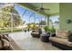 The screened lanai is furnished with comfortable seating, overlooks the backyard, and has a ceiling fan at 3740 Summerwind Cir, Bradenton, FL 34209