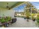 The screened lanai provides an outdoor living space with comfortable seating and access to the backyard at 3740 Summerwind Cir, Bradenton, FL 34209