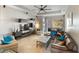 Bright living room with contemporary furniture, large television, and seamless access to the outdoor living space at 3740 Summerwind Cir, Bradenton, FL 34209