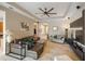 A bright living room featuring tile flooring, a modern ceiling fan, and an open layout at 3740 Summerwind Cir, Bradenton, FL 34209