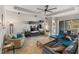 Open living room with tile floors, modern media center, and sliding glass doors to the outdoor patio at 3740 Summerwind Cir, Bradenton, FL 34209